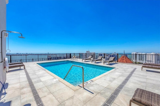 community pool featuring a patio area and fence