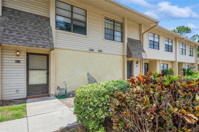 3610 54th St W Unit B4, Bradenton, FL 34209 - doorway to property featuring a shingled roof and stucco siding