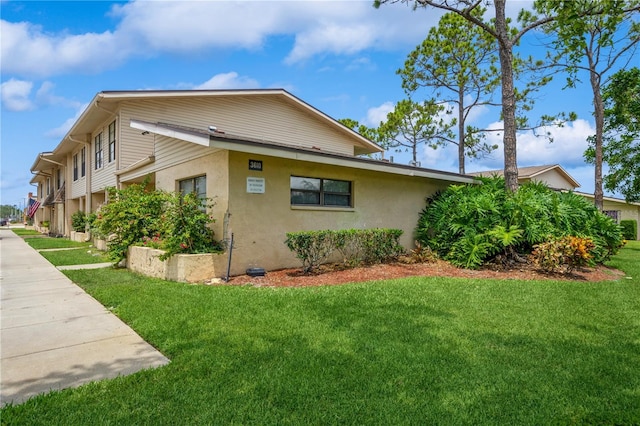 3610 54th St W Unit B4, Bradenton, FL 34209 - view of property exterior with stucco siding and a yard