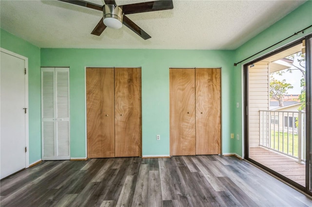 3610 54th St W Unit B4, Bradenton, FL 34209 - unfurnished bedroom featuring dark wood-type flooring, multiple closets, access to exterior, a textured ceiling, and ceiling fan