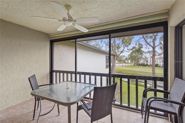sunroom featuring ceiling fan