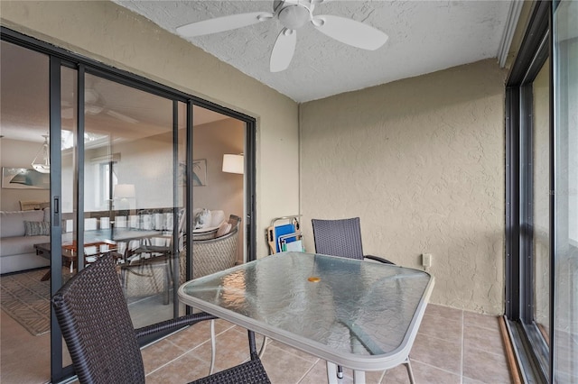 balcony featuring a ceiling fan and outdoor dining area