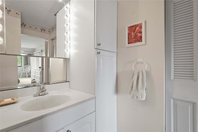 bathroom featuring vanity and a closet