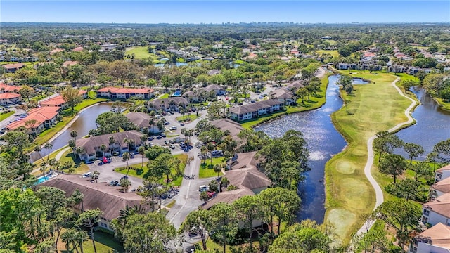 aerial view of property's location featuring a nearby body of water, a local golf course, and nearby suburban area