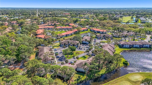 view of property location with a large body of water, a golf club, and nearby suburban area