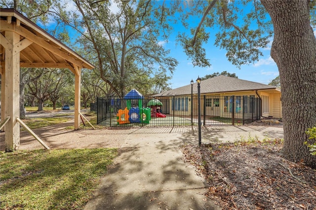 view of jungle gym with fence