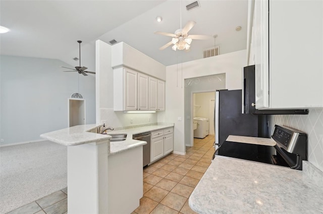 kitchen with a ceiling fan, appliances with stainless steel finishes, washer / dryer, light tile patterned floors, and a peninsula