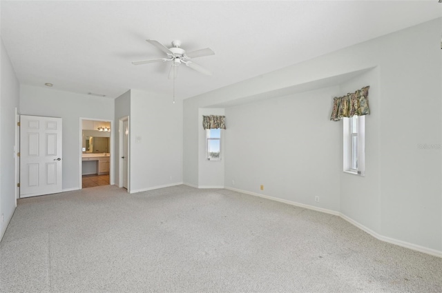 unfurnished room with carpet flooring, a ceiling fan, and baseboards