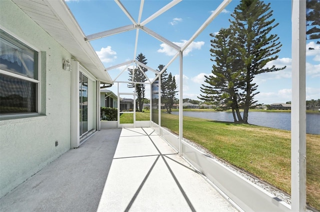 unfurnished sunroom with a water view