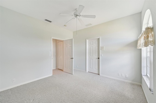 unfurnished bedroom featuring carpet floors, baseboards, and ceiling fan