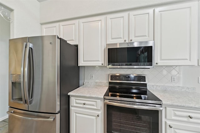 5596 Sabal Trace Dr, North Port, FL 34287 - kitchen featuring stainless steel appliances, decorative backsplash, white cabinetry, and light countertops