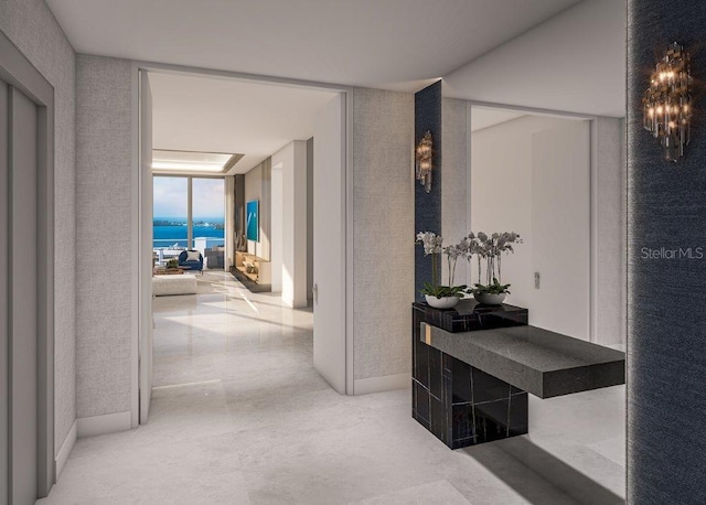 hallway with baseboards and expansive windows