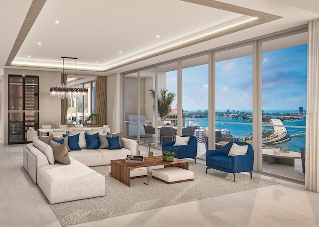 living room featuring a wall of windows, a water view, plenty of natural light, and a tray ceiling