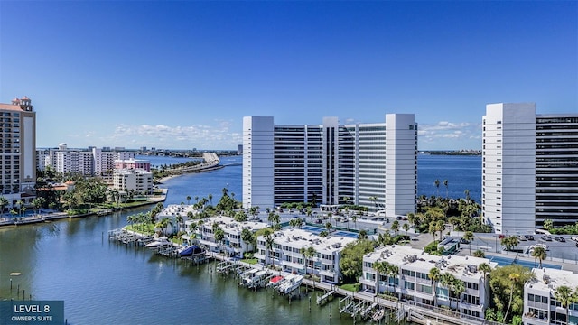 birds eye view of property with a view of city and a water view