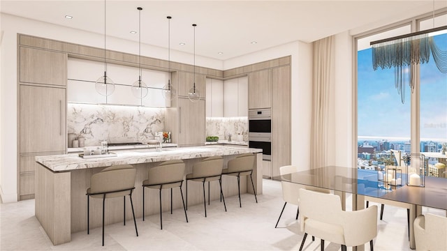 555 Quay Cmn Unit 1601, Sarasota, FL 34236 - kitchen featuring modern cabinets, a kitchen bar, tasteful backsplash, a kitchen island with sink, and floor to ceiling windows
