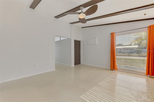 spare room featuring baseboards, ceiling fan, vaulted ceiling with beams, and light speckled floor