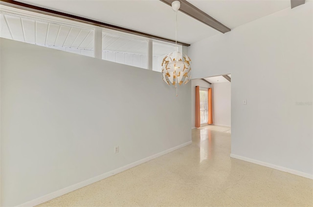 empty room featuring baseboards, beamed ceiling, speckled floor, and a chandelier