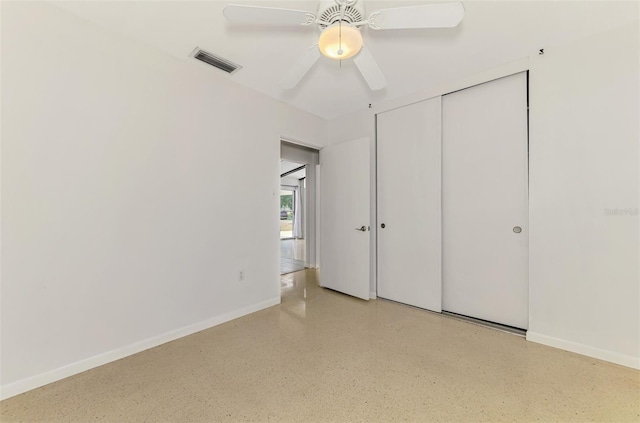 unfurnished bedroom with speckled floor, a ceiling fan, baseboards, visible vents, and a closet