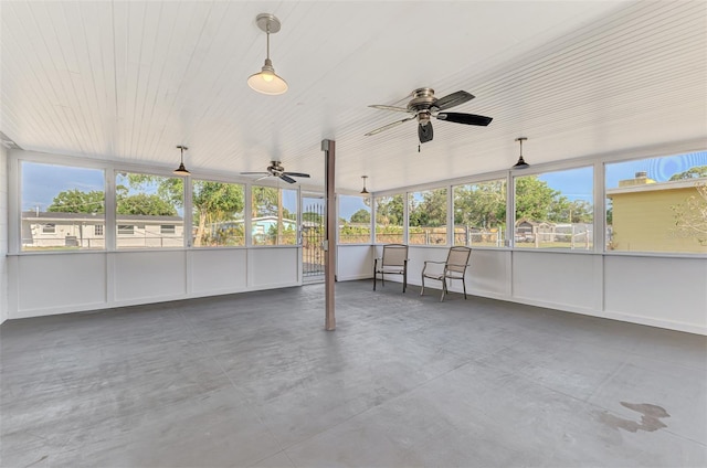 unfurnished sunroom with plenty of natural light and ceiling fan