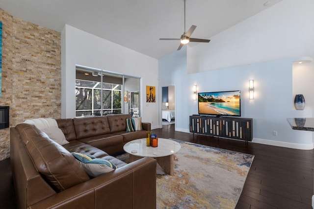 living area with high vaulted ceiling, ceiling fan, baseboards, and hardwood / wood-style floors