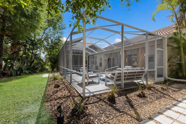 exterior space featuring a tile roof, an outdoor hangout area, an outdoor pool, a lawn, and a patio