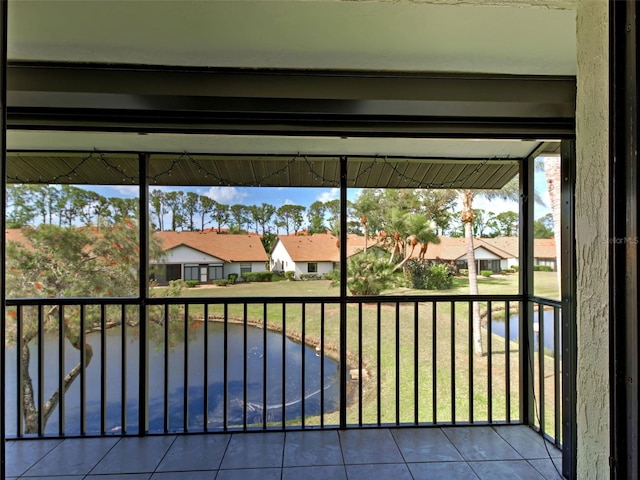 balcony featuring a residential view and a water view