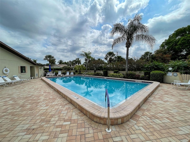 community pool with a patio area