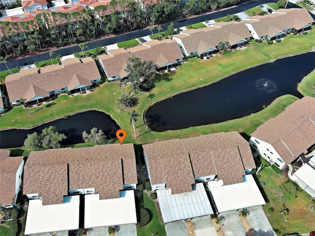 drone / aerial view with a residential view and a water view