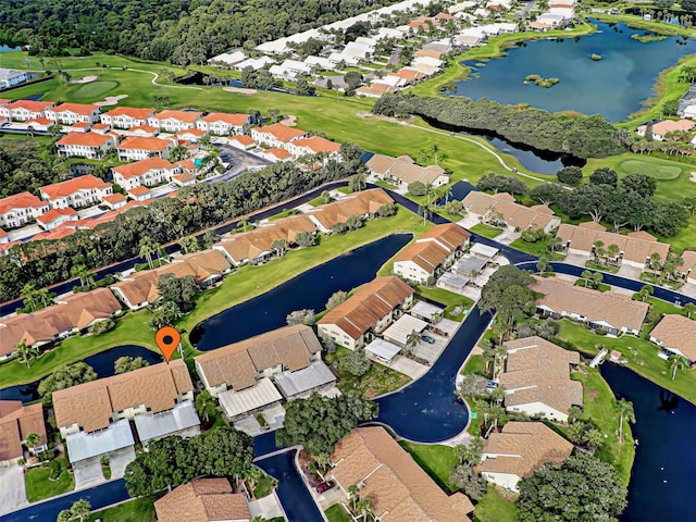 bird's eye view featuring a water view, view of golf course, and a residential view