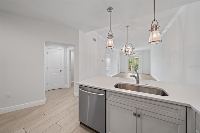 555 N Orange Ave Unit 307, Sarasota, FL 34236 - kitchen featuring dishwasher, a sink, light countertops, baseboards, and hanging light fixtures