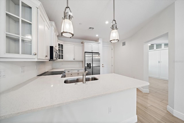 555 N Orange Ave Unit 307, Sarasota, FL 34236 - kitchen with appliances with stainless steel finishes, a sink, baseboards, recessed lighting, and glass insert cabinets