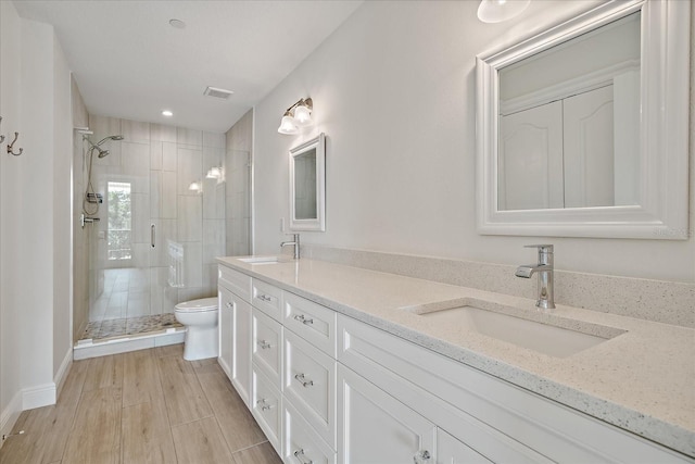 555 N Orange Ave Unit 307, Sarasota, FL 34236 - bathroom featuring toilet, a shower stall, double vanity, and recessed lighting