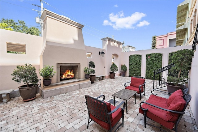 555 N Orange Ave Unit 307, Sarasota, FL 34236 - view of patio / terrace with an outdoor living space with a fireplace