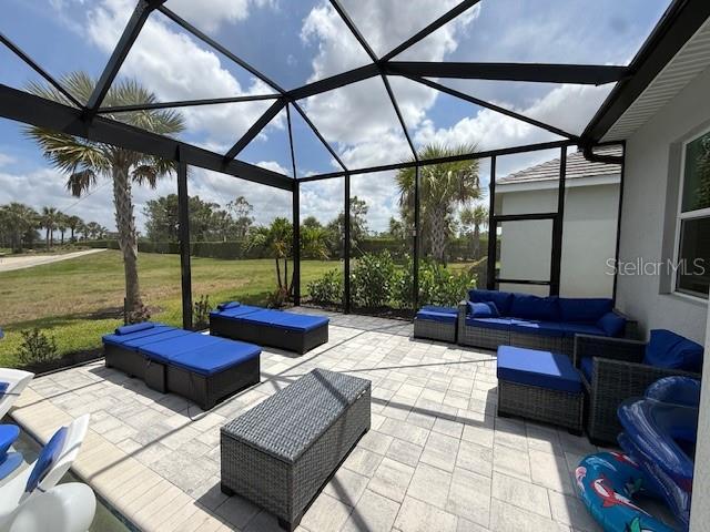 view of patio featuring an outdoor hangout area and a lanai