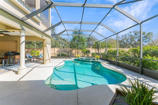 view of swimming pool featuring a fenced backyard, glass enclosure, a patio area, and a pool with connected hot tub