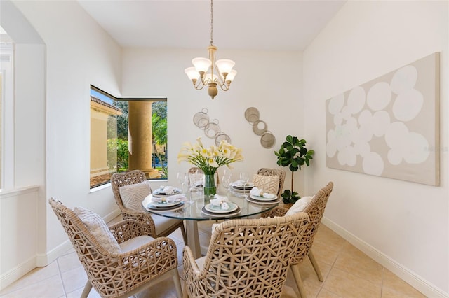 tiled dining space with baseboards, arched walkways, and a notable chandelier