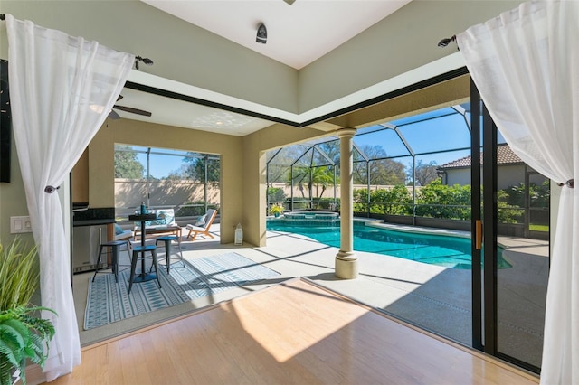 view of pool with a patio area, a lanai, and a pool with connected hot tub