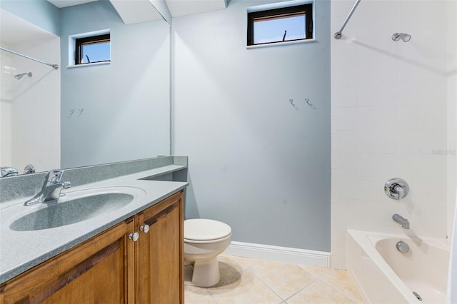 bathroom featuring washtub / shower combination, tile patterned flooring, vanity, toilet, and baseboards