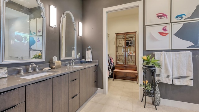 full bath with a sink, tile patterned flooring, and double vanity