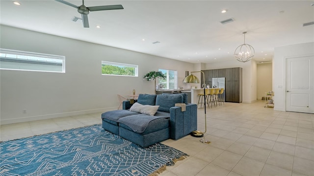 sitting room featuring light tile patterned floors, recessed lighting, visible vents, and ceiling fan with notable chandelier