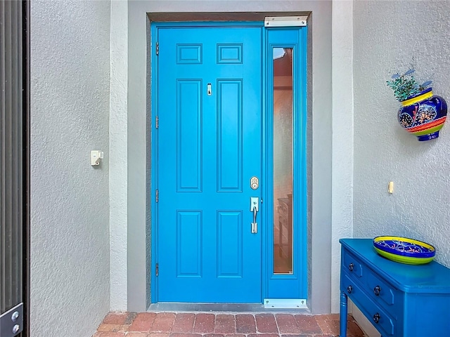 entrance to property with stucco siding