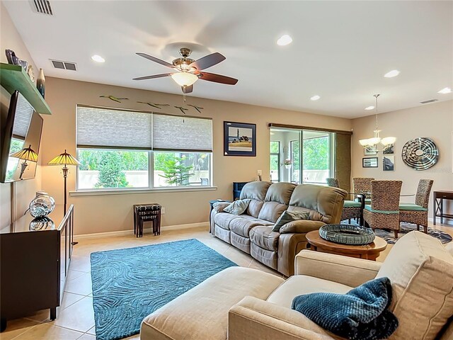 living room featuring a chandelier, a ceiling fan, light tile patterned flooring, recessed lighting, and baseboards