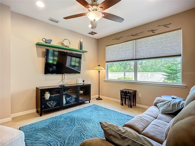 living area with tile patterned flooring, a ceiling fan, baseboards, and recessed lighting