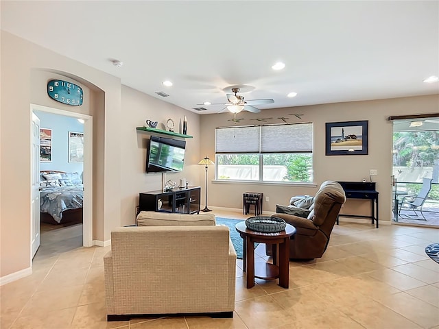 living area with light tile patterned floors, a ceiling fan, recessed lighting, and baseboards
