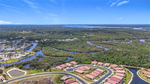 aerial view with a water view, a forest view, and a residential view