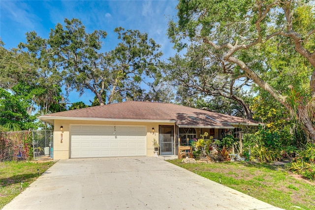 620 Burke Rd, Venice, FL 34293 - ranch-style house with driveway, stucco siding, a garage, and fence