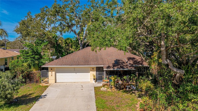 620 Burke Rd, Venice, FL 34293 - ranch-style house with an attached garage, stucco siding, fence, concrete driveway, and roof with shingles