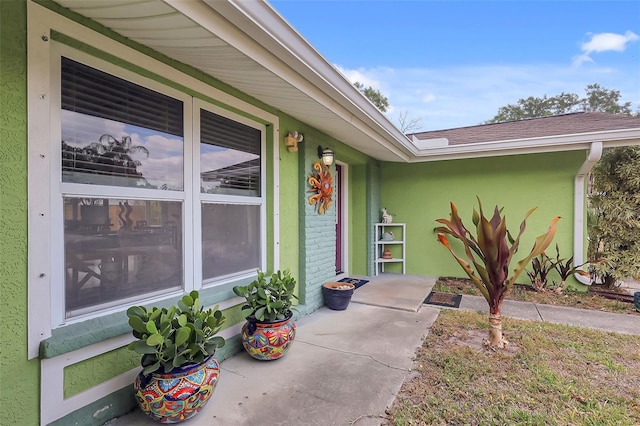 doorway to property with stucco siding