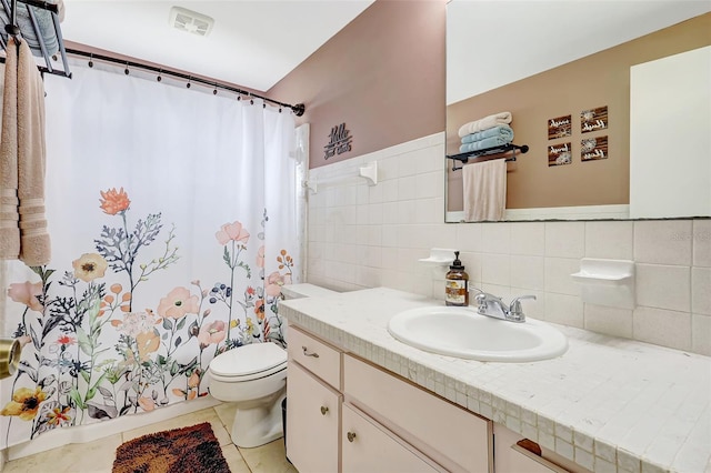 full bathroom with a shower with curtain, visible vents, vanity, tile patterned floors, and toilet