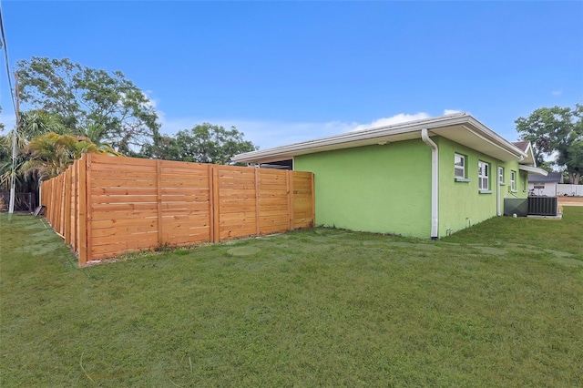 view of yard with fence and cooling unit